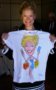 A girl holding up a shirt with a caricature of her on it